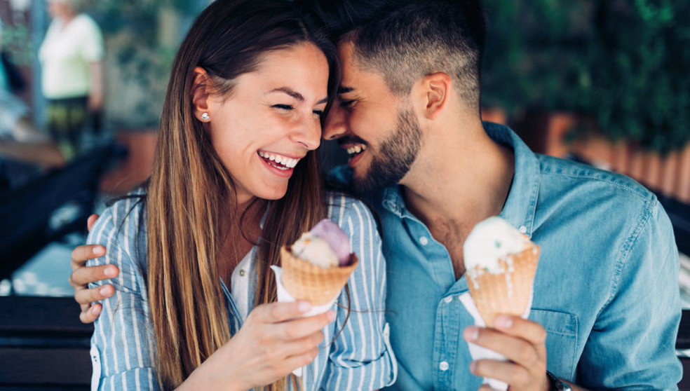 Happy young couple having date and eating ice cream