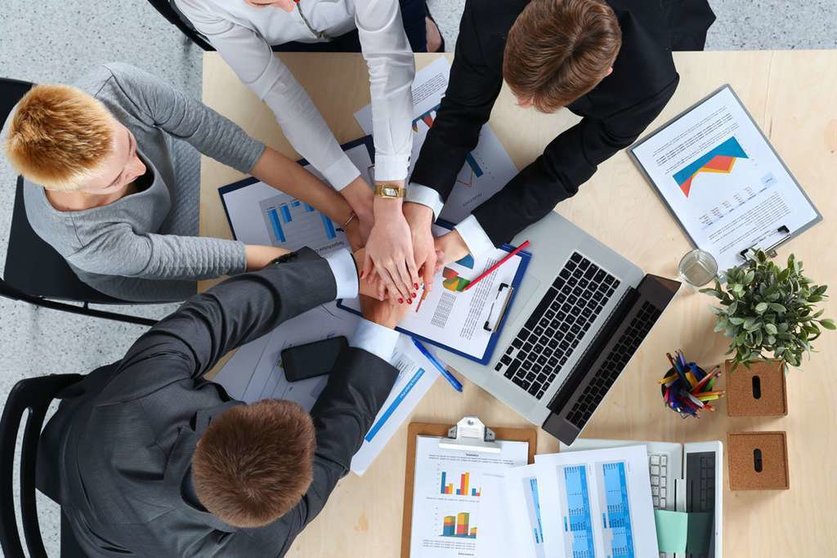 Business team with hands together - teamwork concepts, isolated