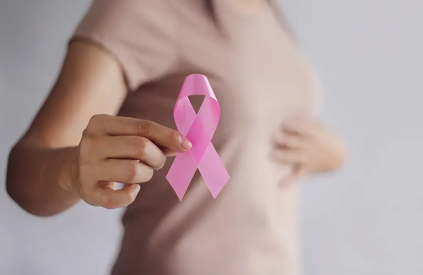 Breast Cancer Awareness Concept.  Health care and medical. Hand of woman holding pink ribbon awareness symbol for endometriosis, Medicine. Prevention Breast.
